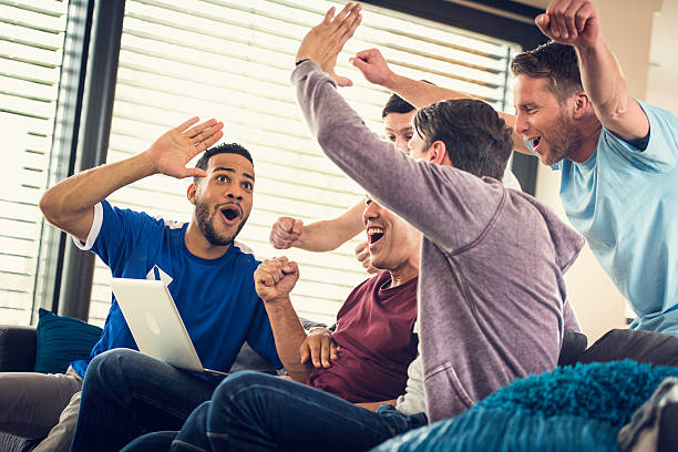 istock Group of frends watching game on laptop 585606844