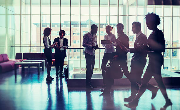 istock Business people walking in the office building lobby 585608076