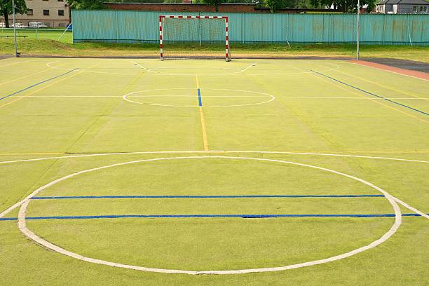 istock Empty outdoor handball playground, plastic light green surface 585608928