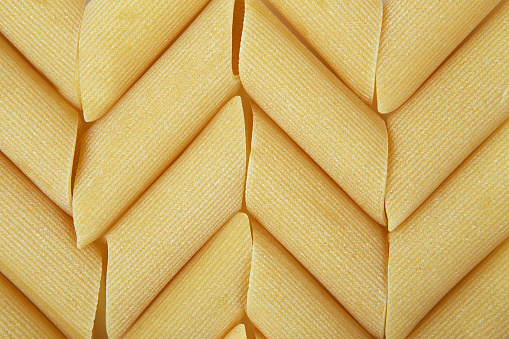 Manicotti pasta. Mostaccioli pasta. Background of italian penne, traditional pasta