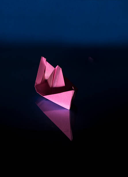istock pink paper boat 585611478
