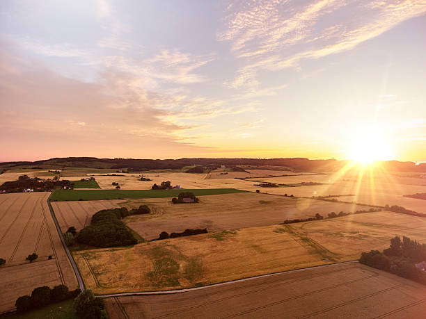 istock Sunrise and farmland 585611872