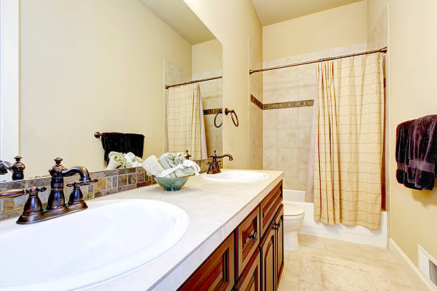 istock Beige tone bathroom interior with tile wall trim. 585612508
