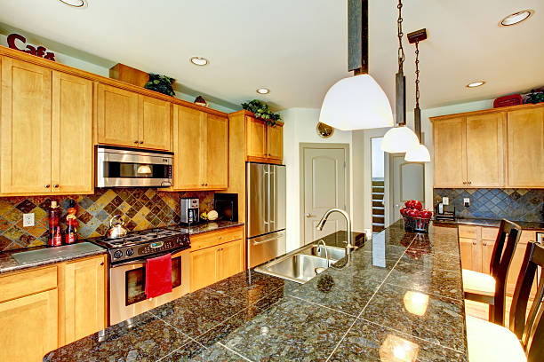 istock Kitchen room with brown cabinets, stainless steel, granite counter top. 585612650