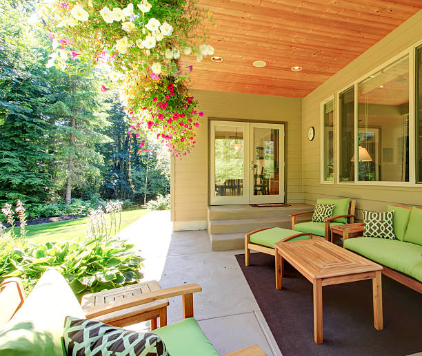 istock Cozy backyard concrete floor patio area with table set. 585612692