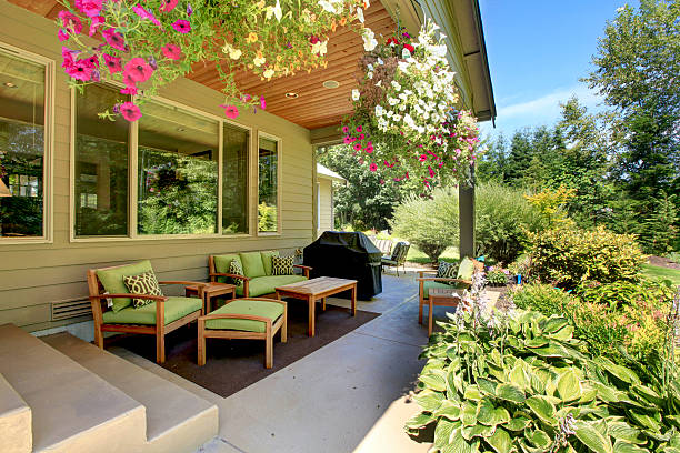 istock Cozy backyard concrete floor patio area with table set. 585613366