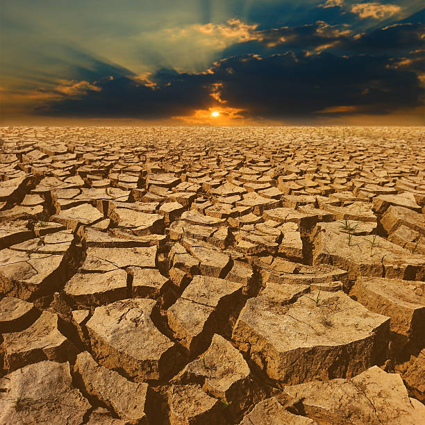 istock crack earth with beautiful sky at sunset 585616390