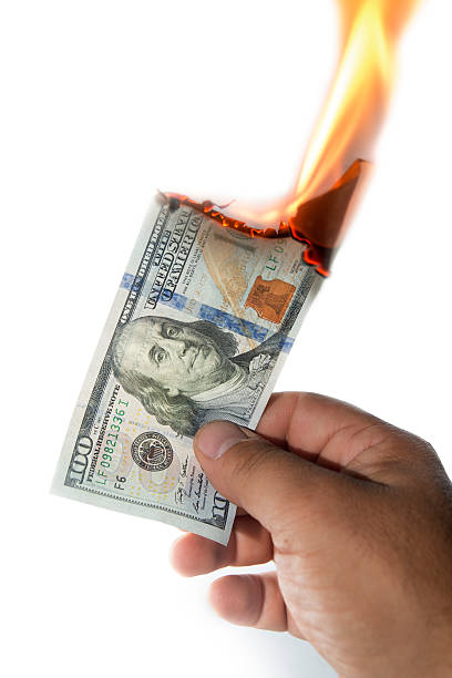 istock destroying one hundred dollars 585618590