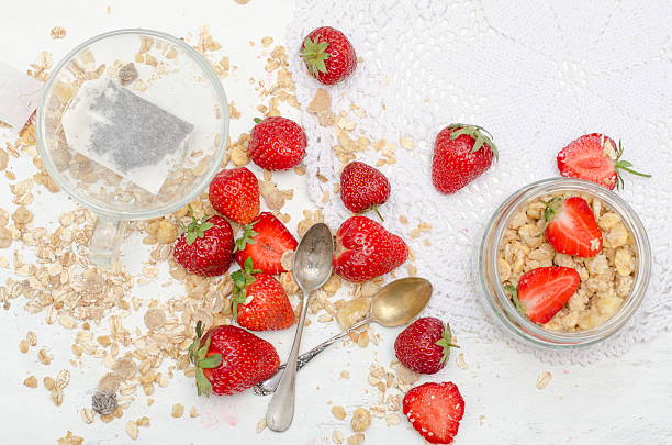 istock Ripe strawberries and tea with scattered muesli 585619640