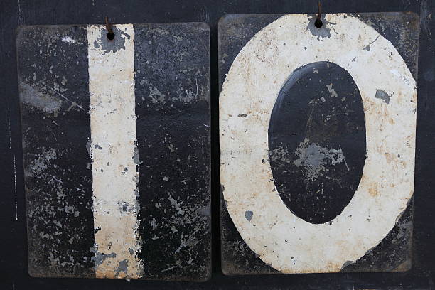 The number 10 (ten) is depicted using numbers on an old tin cricket scoreboard.  Suitable for birthday invitation.
