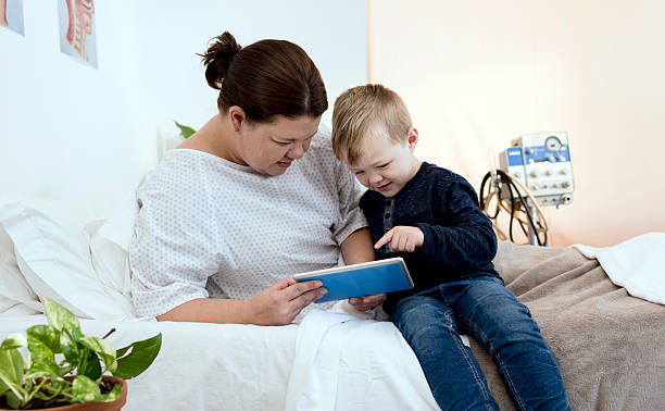 istock Female Hospital Patient With Her Young Son 585620520