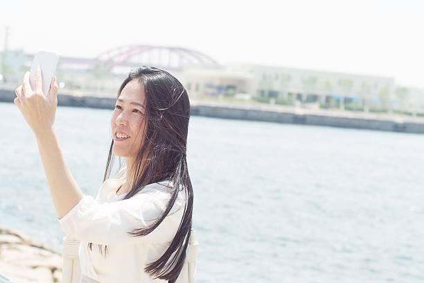 istock Japanese woman Taking a selfie 585621352