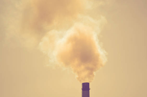 istock silhouette of a pipe with smoke background sky sun backlight 585621944