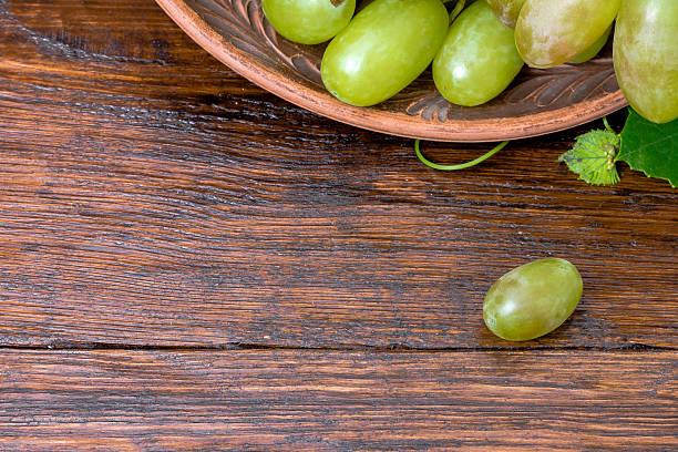 istock green grapes on a wooden table 585624942