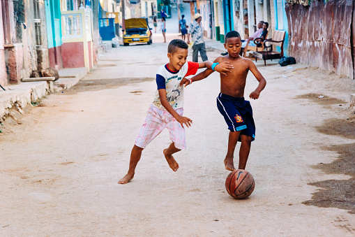 Trinidad, Cuba - March 23, 2015: Cuban boys playing soccer in the street.