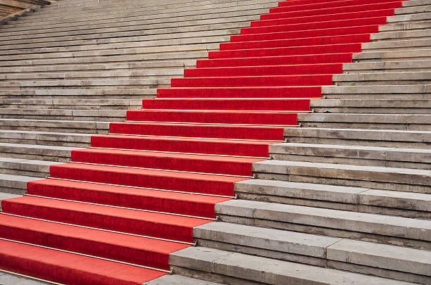istock Red carpet on stone stairs 585629502