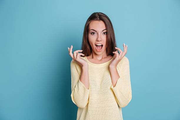 istock Surprised young beautiful girl looking at the camera 585763070