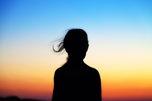 Silhouette of girl at sunset