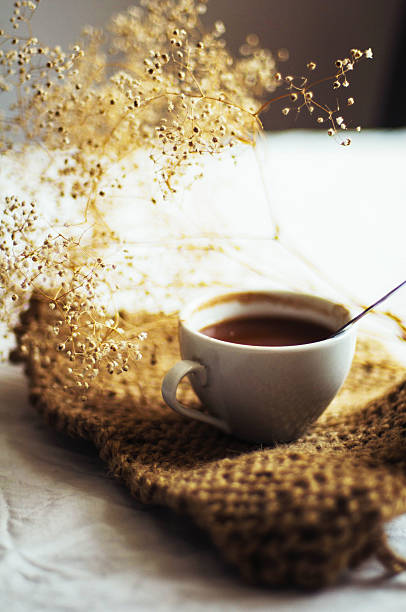 istock Fresh hot coffee on a pile of books on a table 585763454