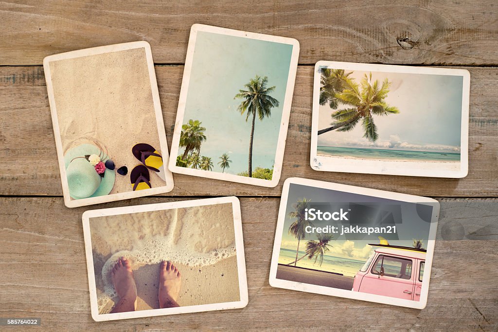 summer photo album Photo album remembrance and nostalgia journey in summer surfing beach trip on wood table. instant photo of vintage camera - vintage and retro style Photograph Stock Photo
