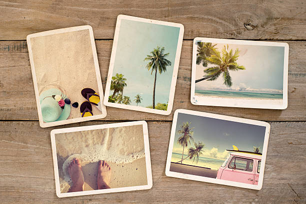 summer photo album Photo album remembrance and nostalgia journey in summer surfing beach trip on wood table. instant photo of vintage camera - vintage and retro style surfing photos stock pictures, royalty-free photos & images