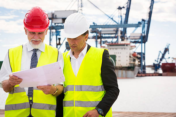 istock workers in industrial port 585764940