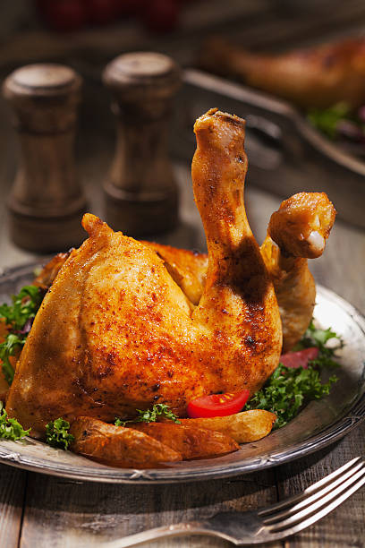 istock Baked chicken leg, served with roasted potatoes and vegetables. 585765144