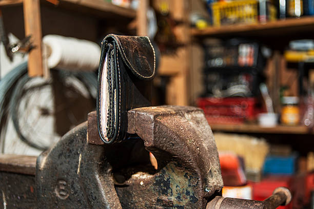 istock money clamped in a vise 585767978