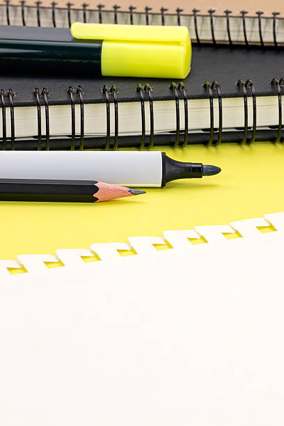 istock piece of sheet notebook and markers on yellow table background 585768918