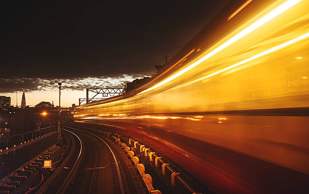 station with fast contemporary train in london - docklands light railway imagens e fotografias de stock