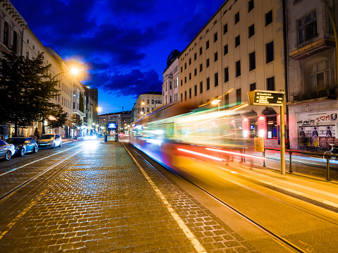 Berlin, Germany - June 11, 2013: A bus passing by a bus station in a street in Berlin, Germany at night.