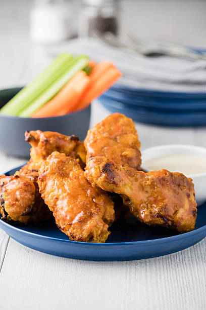 istock Buffalo chicken wings with celery carrot sticks 585771012
