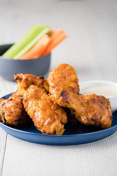 istock Buffalo chicken wings with celery carrot sticks 585771846