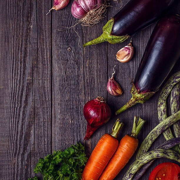 istock Fresh vegetables for cooking on dark wooden background. 585773696