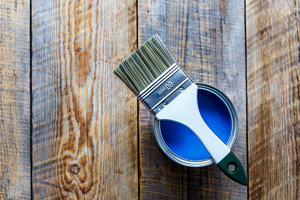 istock jar with blue paint on the wooden background top view 585774302