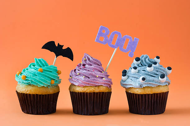 Halloween cupcakes Halloween cupcakes on orange background halloween cupcake stock pictures, royalty-free photos & images