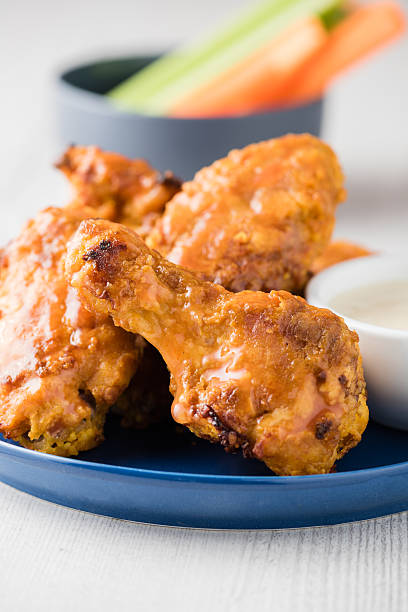 istock Buffalo chicken wings with celery carrot sticks 585776016