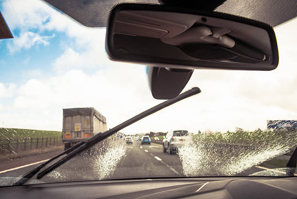 istock Clearing the windscreen while driving to improve visibility in t 585777684
