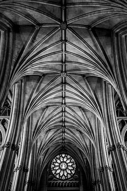 Bristol, United Kingdom - July 31, 2016: Black and white image showing an interior view focusing on the ceiling, window, arches and ornate stone work of the iconic Bristol Cathedral.