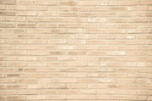 Beige-brown grunge brick wall texture or dirty surface pattern for background and backdrop, architectural element in urban concept, retro or vintage style
