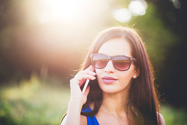istock Young girl using phone in the nature 585779462