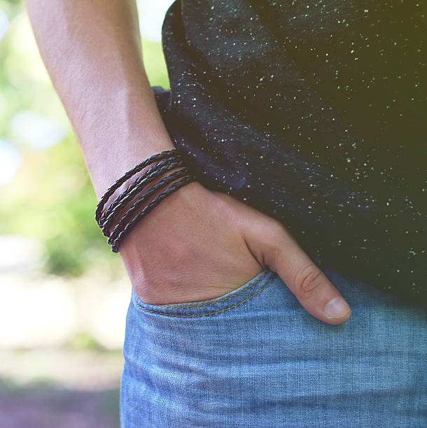istock Male standing with leather bracelet on his hand 585780400