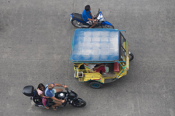 Rickshaw in the Philippines Dumaguete, Philippines - February 19, 2015: Rickshaw motorised tricycle in the Philippines. Theses vehicles are a popular sight throughout the Philippines and used as taxi and public transport philippines tricycle stock pictures, royalty-free photos & images