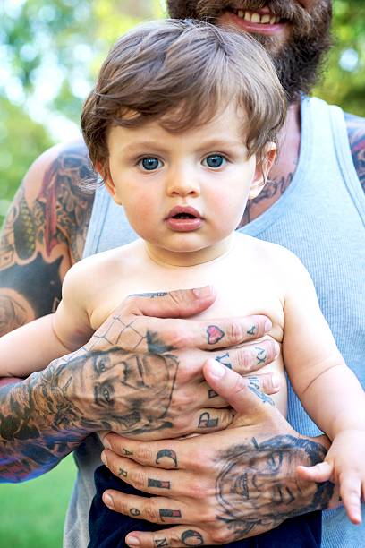 istock Tattooed Father and Son Portrait 585780608