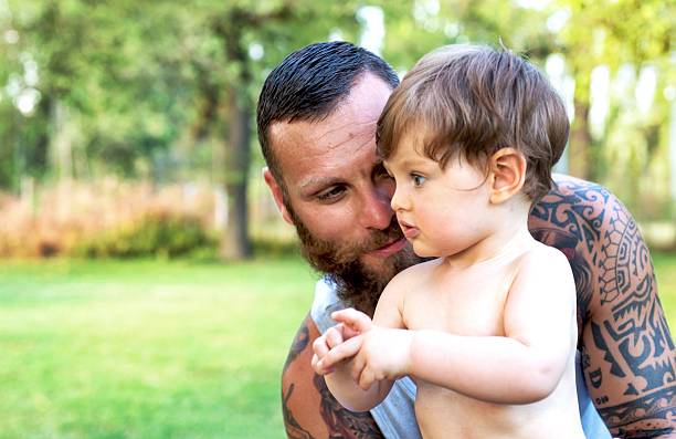 istock Tattooed Father and Son Portrait 585780906