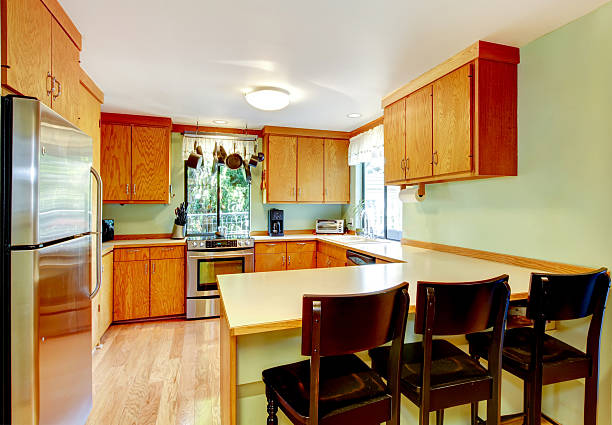 istock Bright kitchen with light brown cabinets and old wooden stools. 585781278