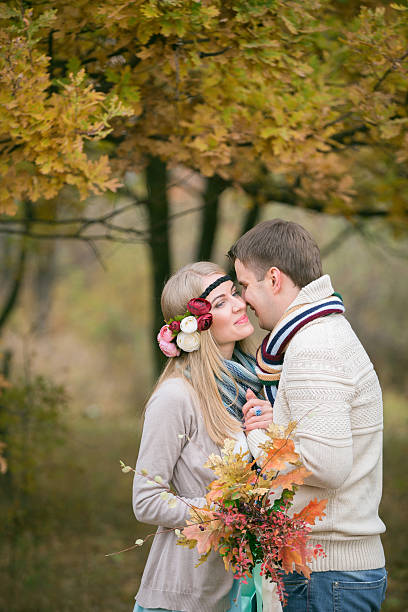istock loving couple in autumn park. 585781492
