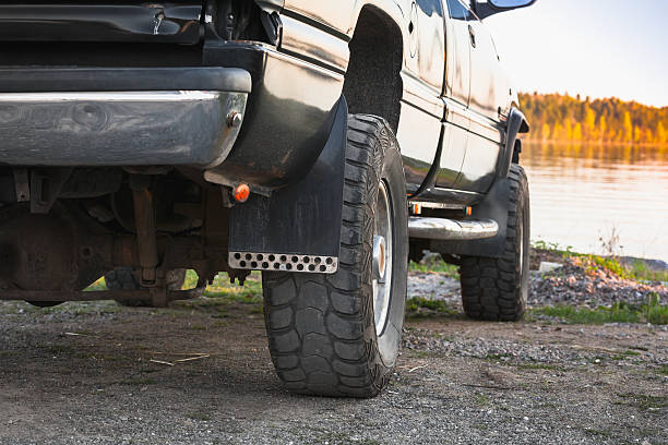 istock Black SUV car fragment. Still lake coast 585781624