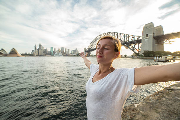 istock Young woman relaxing in Sydney harbour at sunset 585782304