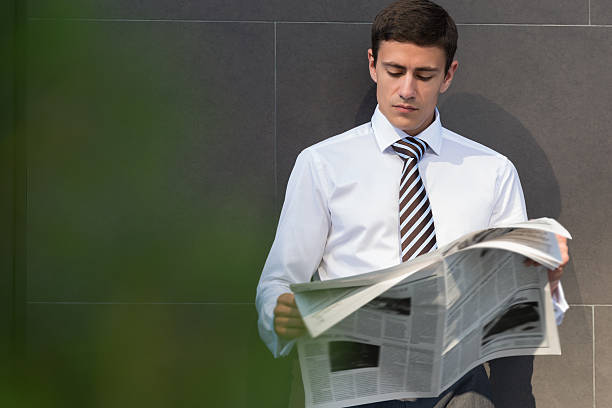 istock Businessman reading newspaper 585784060